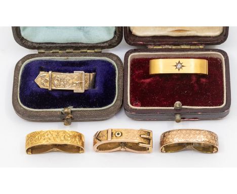 A collection of late Victorian early Edwardian gold scarf/cravat clips, including a 9ct gold clip, star set to the centre wit