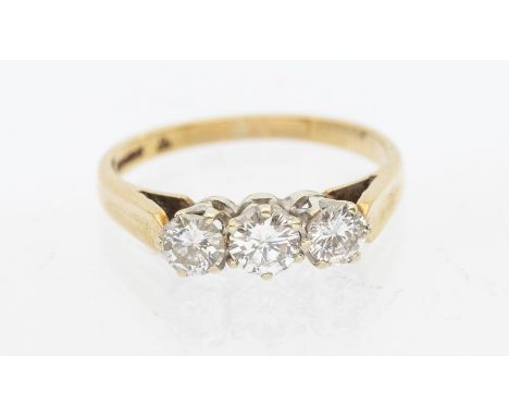 A diamond and 9ct gold three stone ring, comprising three round brilliant cut diamonds, total diamond weight approx 0.60ct, c