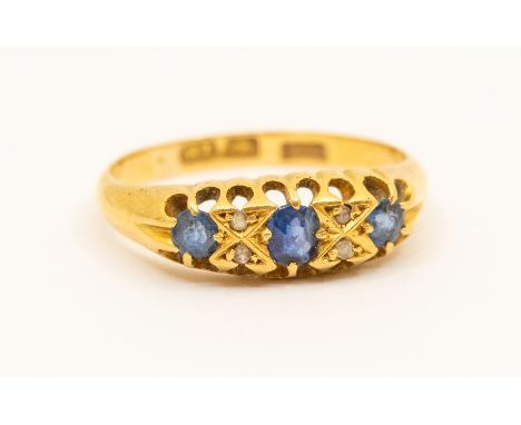 A sapphire and diamond 18ct gold boat head ring, comprising oval and round mixed cut sapphires with small diamond accents, to