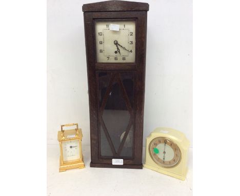 1930s' oak wall clock, ivory-coloured Bakelite mantel clock, and a carriage clock.