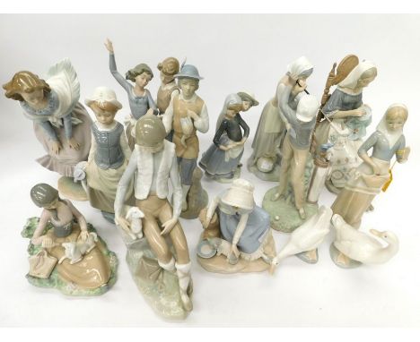 A collection of Lladro and Nao figurines, mostly of children, a golfer, a lady sitting on a chair, four boxed including two N