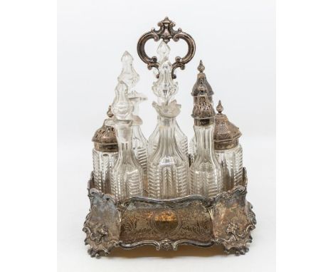 A Victorian silver plated condiment stand, the body with engraved decoration on scroll supports, centre section with ring han