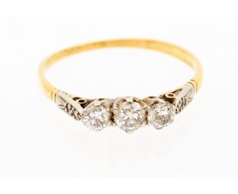 A three stone and 18ct gold ring, comprising three white stones, platinum set to a gold band, size P, total gross weight appr