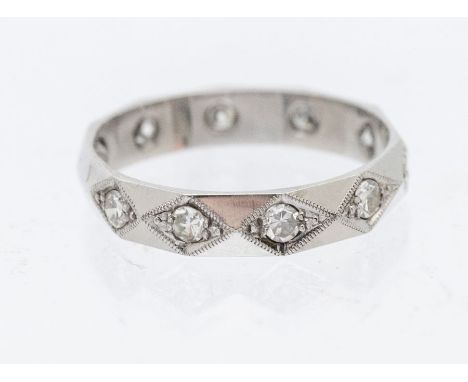  A diamond set 18ct white gold dress ring, comprising faceted details grain set with small round brilliant cut diamonds, widt