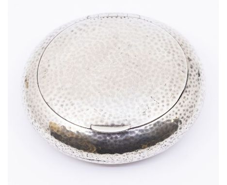 An Arts &amp; Crafts silver circular mottled tobacco box and cover, hallmarks indistinct, date letter O probably London, 1909