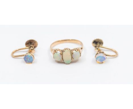 A three stone opal and 9ct rose gold ring, comprising three oval graduated opals, (abraded) size K, total gross weight approx