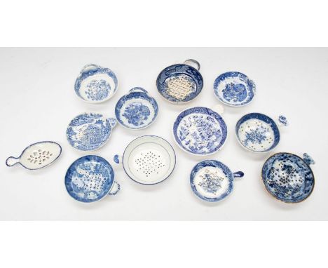 A collection of various blue and white ceramic tea strainers to include; a small oval spoon shaped, the rest being of circula