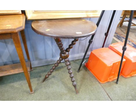 Circular Gypsy style table raised on tripod bobbin turned legs 