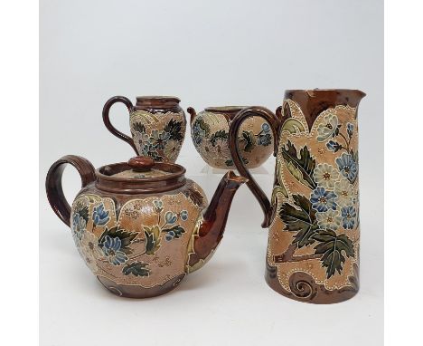 A Doulton Lambeth three piece tea set, and a similar jug, 20 cm high (4) 