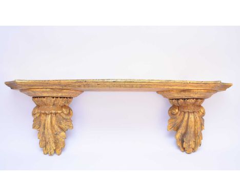 A giltwood wall bracket or shelfProbably late 19th century, the moulded serpentine-fronted shelf supported by two acanthus fo
