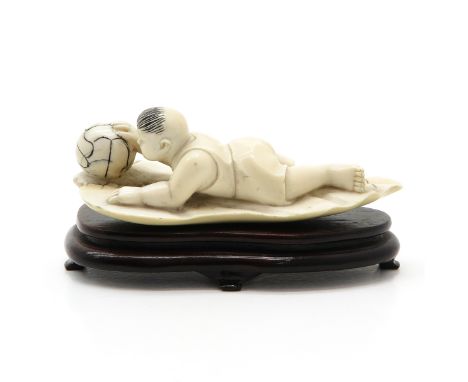 carving, depicting child with ball, 5 cm. tall, on wood base, this item may not be shipped outside of the European Union. 