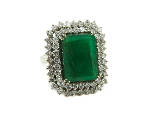 Set with 50 diamonds of approximately 3.50 carat, emerald is approx. 24 carat measuring 12 x 15 mm., ring size 18.