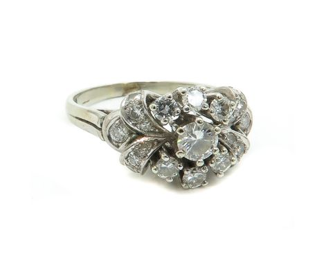 Set with 21 diamonds, largest stone is 4.4 mm. in diameter, ring size 18.