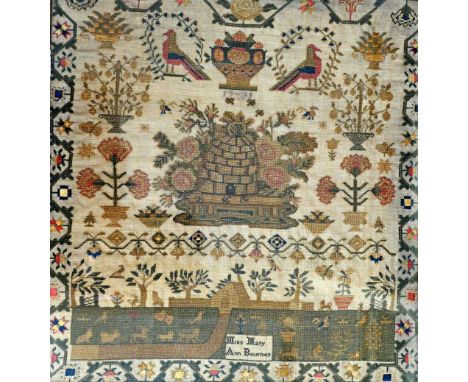 A George III needlework sampler dated 1791 by Miss Mary Ann Bournes, centrally detailed with a beehive or skep over a landsca