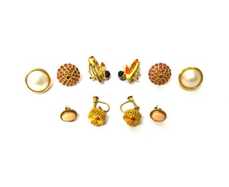 A pair of gold and coral set oval earstuds, the backs with post and butterfly clip fittings, a pair of ruby set cluster earri