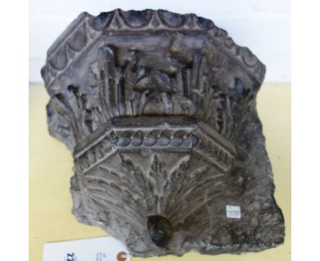 A Spanish black marble vaulting bracket, probably 16th century, of half octagonal form, with foliate carved decoration (a.f),