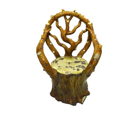 A late 19th century glazed earthenware garden seat of naturalistic tree trunk form, 120cm high.   Illustrated