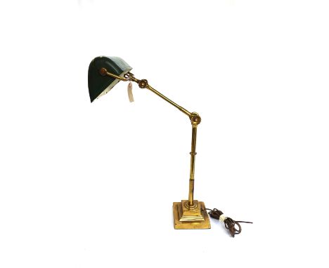 A Victorian brass and adjustable desk lamp with green enamel shade over a stepped square loaded base. 