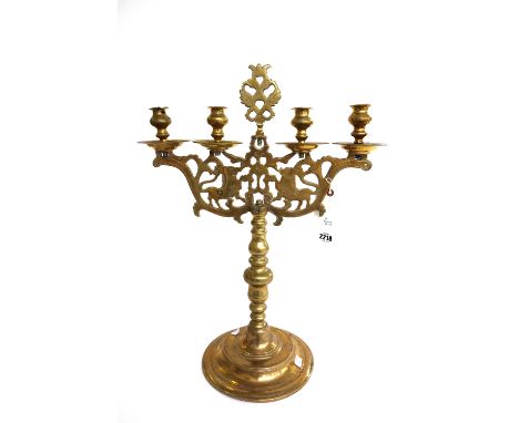 A matched pair of German four light brass candelabra, 18th century and later, one with Hebrew inscription, both with mytholog