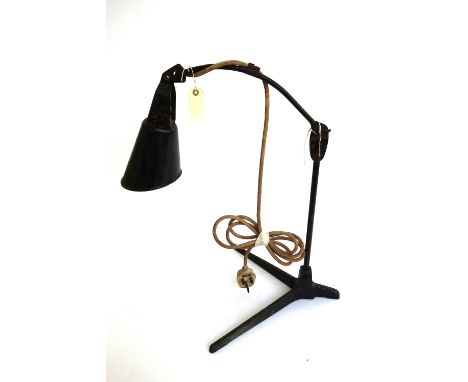 A vintage black painted industrial metal desk lamp, the angular tapering shade on an adjustable arm and cast iron tripod base