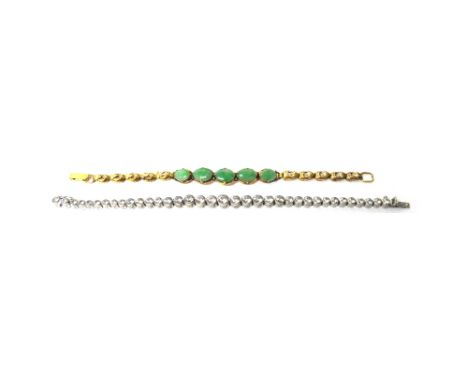 A gold and jade set bracelet, mounted with a row of five oval cut jades to the centre, on an oval clasp detailed 585, length 