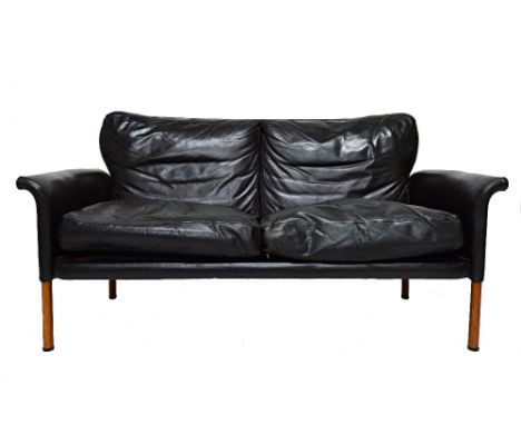 A 20th century design Danish teak framed leather upholstered sofa on turned supports, 143cm wide. Illustrated