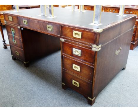 A brass bound mahogany campaign style pedestal desk with nine drawers about the knee on bracket feet, 152cm wide.  