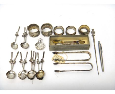 A silver caddy spoon, Sheffield 1946, five various mostly souvenir teaspoons, a pair of silver sugar tongs, with bright cut e