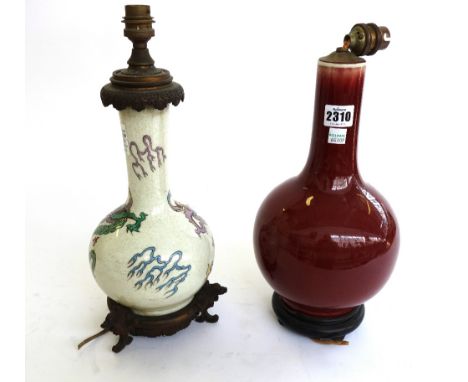 A Chinese sang-de-boeuf vase table lamp, 20th century, raised atop a wooden stand, (vase 29cm high) and another Chinese vase 