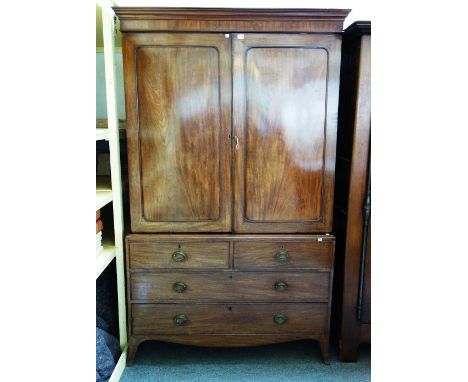 A George III mahogany linen press, the pair of doors over two short and two long graduated drawers on splayed bracket feet, 1