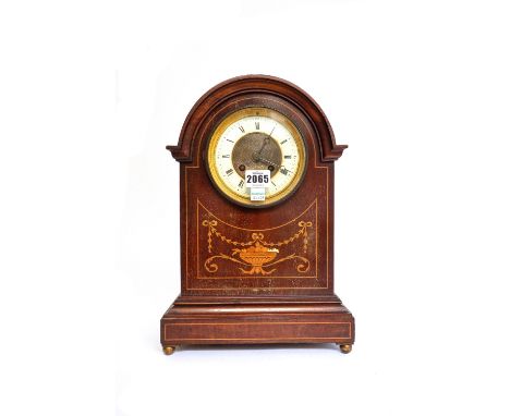 An Edwardian mahogany and inlaid mantel clock with domed case, enamel chapter ring with urn and swag inlay, 35.5cm high and a