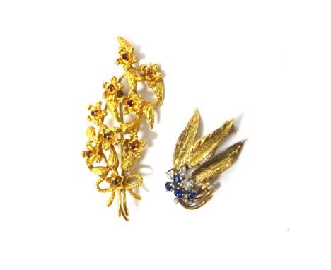 A 9ct gold and ruby set brooch, designed as a floral and foliate spray, London 1974 and a 9ct gold, sapphire and diamond set 