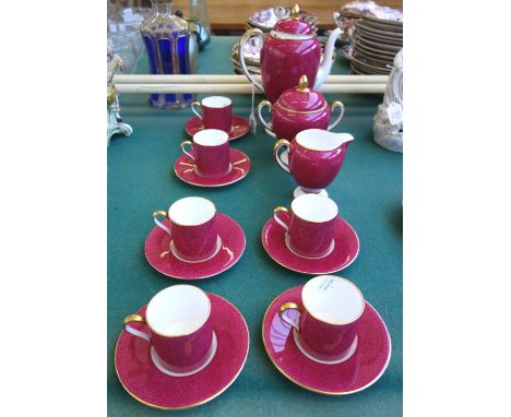 A Wedgwood bone china puce ground coffee service enriched in gilding, comprising; coffee pot and cover, sucrier and cover, mi