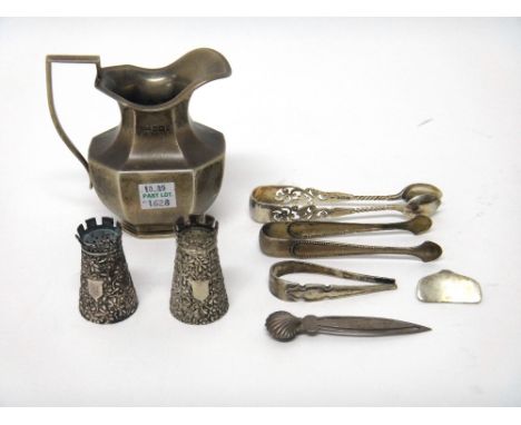 A pair of Victorian silver pepperettes, each designed as a chess piece castle, with floral and foliate decoration, London 188