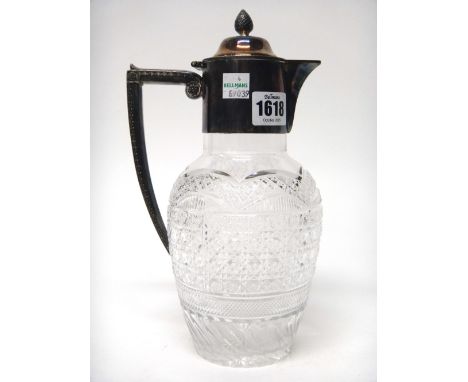 A late Victorian silver plated metal mounted, faceted glass claret jug, of baluster form, with a decorated angular handle and