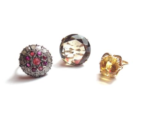 A gold ring, claw set with an oval cut citrine, detailed 585, a gold ring, claw set with a large circular cut smoky quartz, d