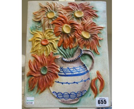 A Goldscheider pottery wall plaque, 20th century, of rectangular form, decorated in relief with a vase of flowers, 27.5cm x 2