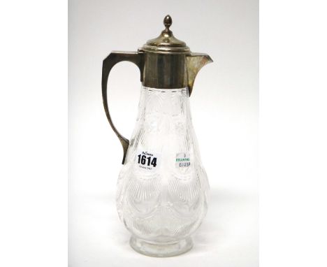 A silver mounted, faceted glass claret jug, the body of baluster form, the hinged lid with an egg shaped finial, London 1903.