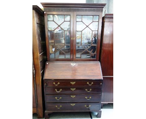 A George III mahogany bureau bookcase, the pair of astragal glazed doors over fitted interior and fall over four long graduat