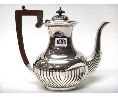 A silver coffee pot, with partly curved fluted decoration to the body, with an angular composition handle and finial and on a