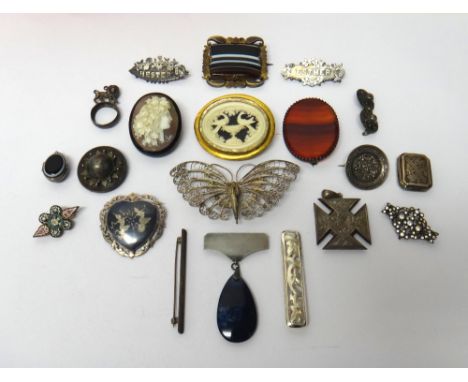 An oval shell cameo brooch, carved as the portrait of a lady, a rectangular banded agate set brooch, a filigree butterfly bro