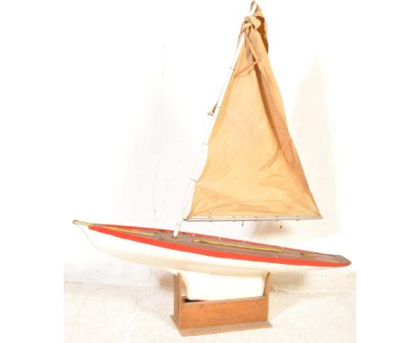 A retro vintage mid 20th century pond yacht of wooden construction painted in a red and white colourway. Measures approx. 124