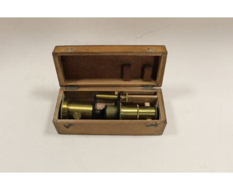 A CASED VINTAGE BRASS MICROSCOPE OF SMALL PROPORTIONS
