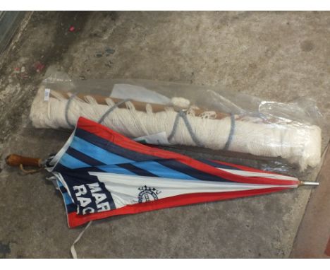 A VINTAGE HAMMOCK TOGETHER WITH A MARTINI INTERNATIONAL CLUB RACING UMBRELLA