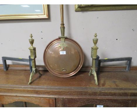 A PAIR OF VINTAGE BRASS AND CAST FIRE DOGS AND A WARMING PAN