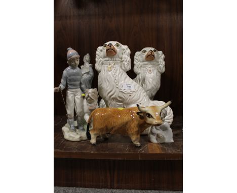 A PAIR OF LARGE STAFFORDSHIRE STYLE DOG FIGURES, TOGETHER WITH TWO NAO FIGURES AND ANOTHER (5)