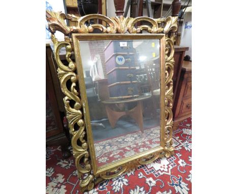 A MODERN DECORATIVE GILT WALL MIRROR 93 X 69 CM