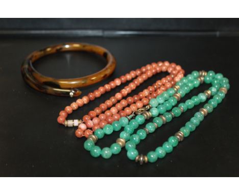 A VINTAGE GOLDSTONE SINGLE STRAND BEAD NECKLACE, approx length 52 cm, together with another polished green hardstone bead nec