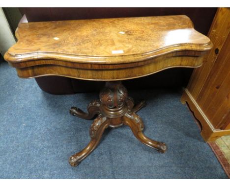 A MID VICTORIAN WALNUT SHAPED FOLD-OVER CARD TABLE ON CARVED SUPPORTS W-91 CM