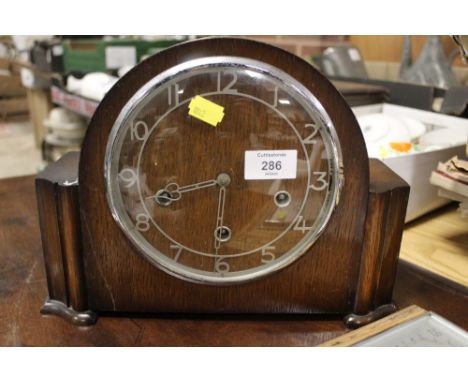 A VINTAGE OAK MANTLE CLOCK AND A BAROMETER